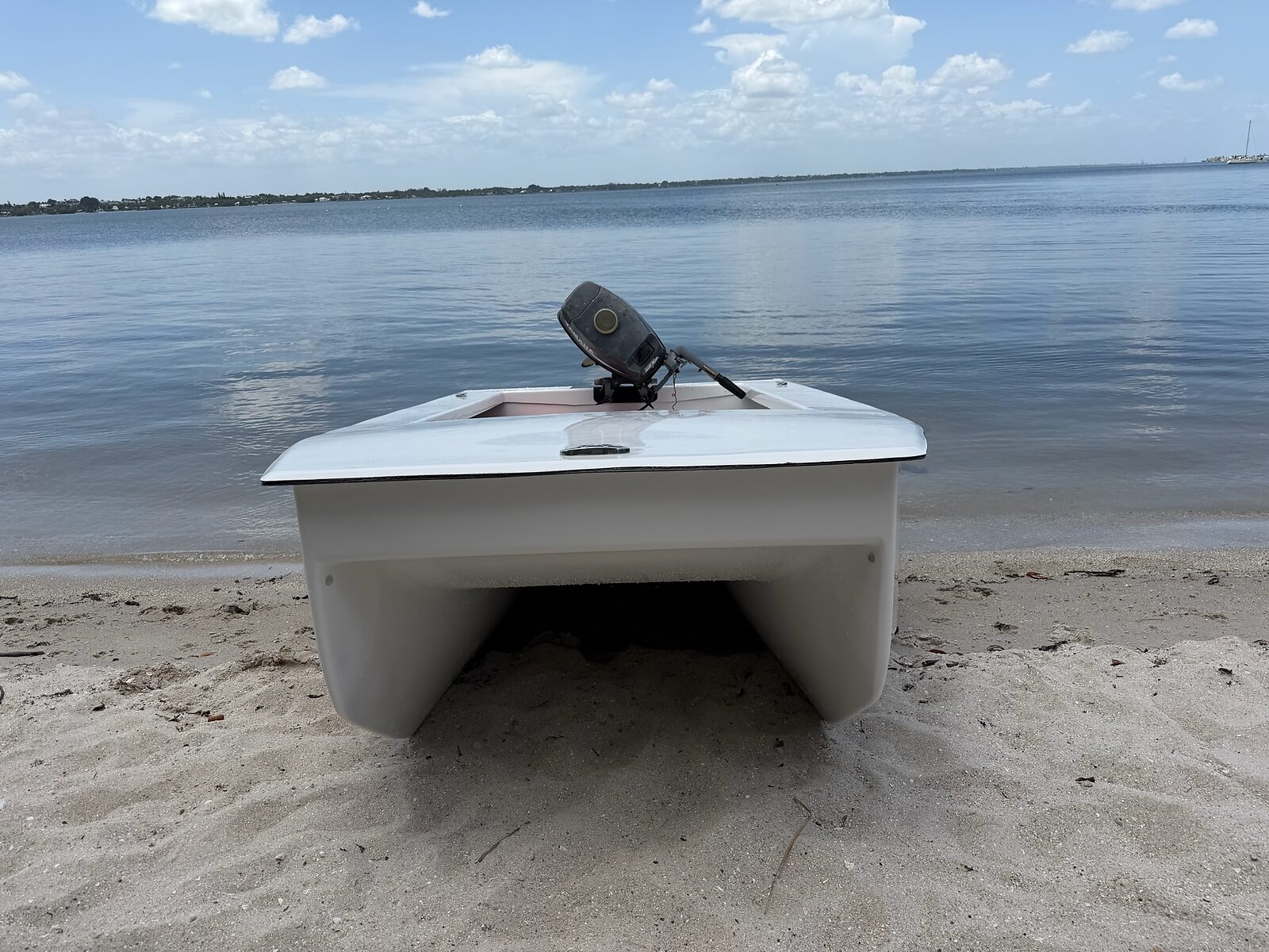 Cape Cat 115 bow-on, beached on a sandbar