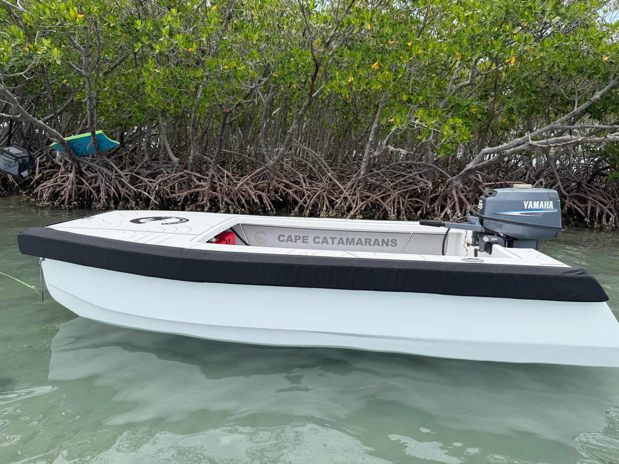 Cape Cat 115 broadside at rest, hull name along the gunwale