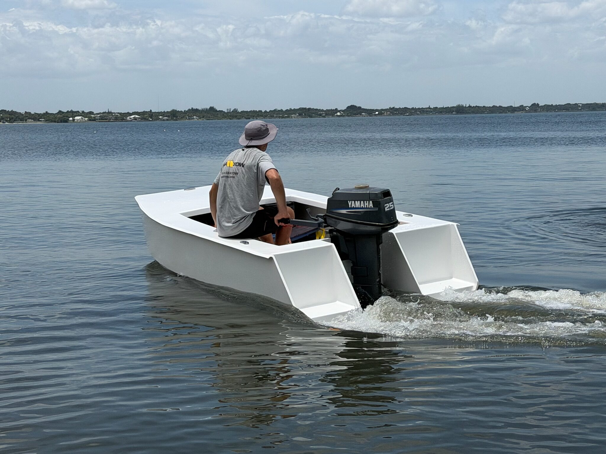 Cape Cat 115 under power, wake curling off both hulls