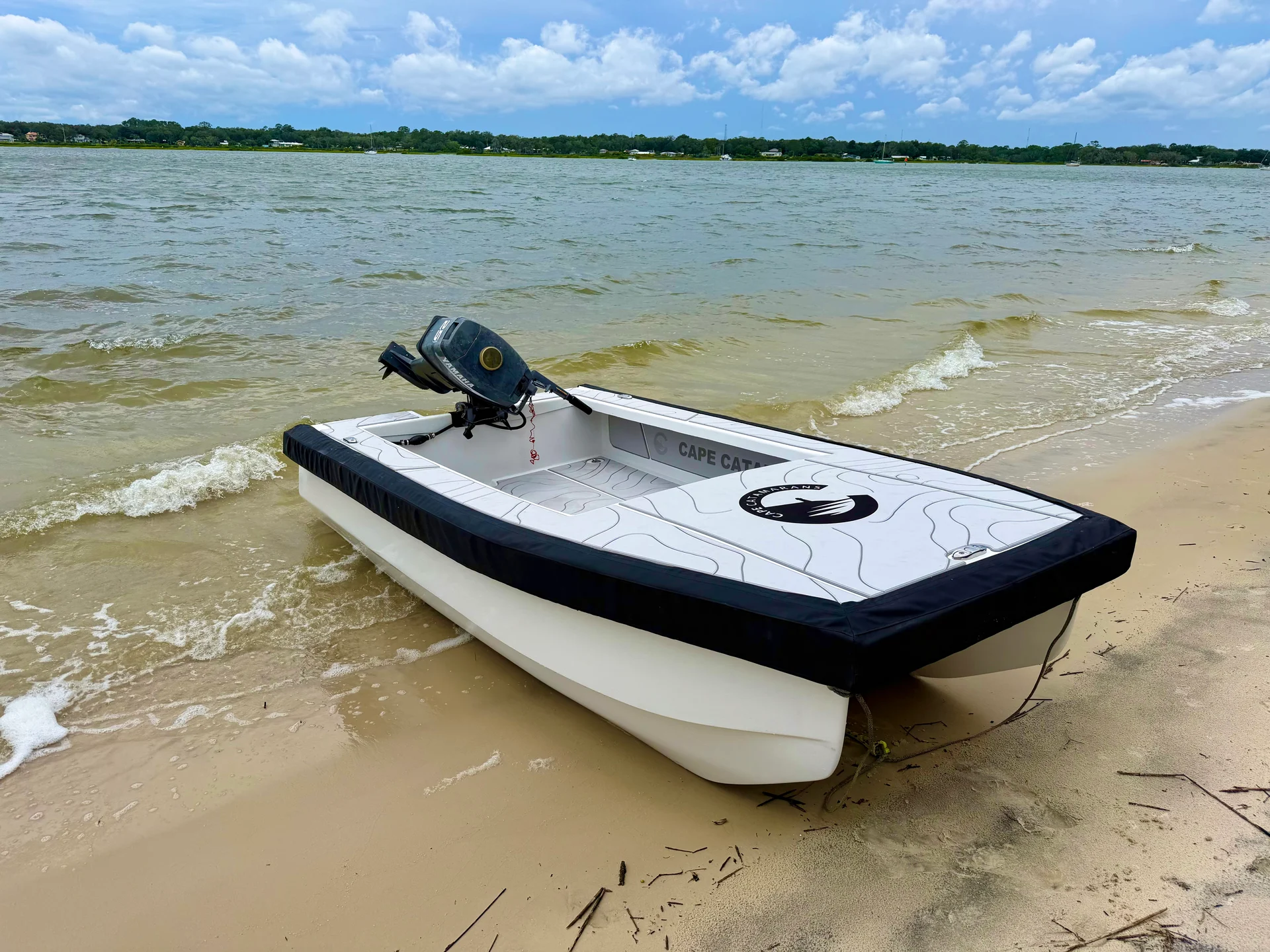 Cape Cat 115 beached, three-quarter view
